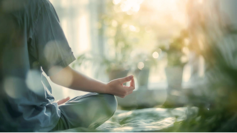 person sitting in soft morning light meditating by a window, reflecting inner connection and self-alignment