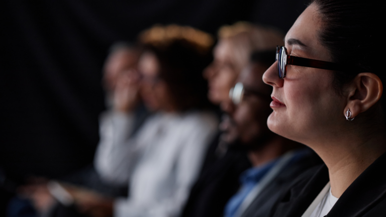 Thoughtful professional woman looking ahead, reflecting on how to turn passion into purpose.