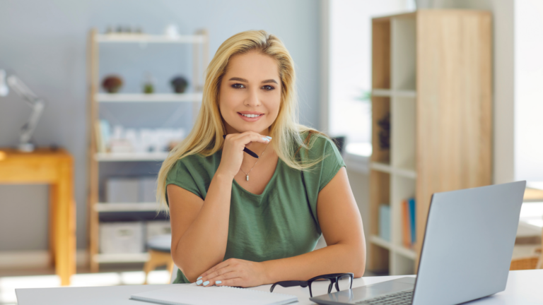 Woman considering whether to become a professional coach while sitting at her desk